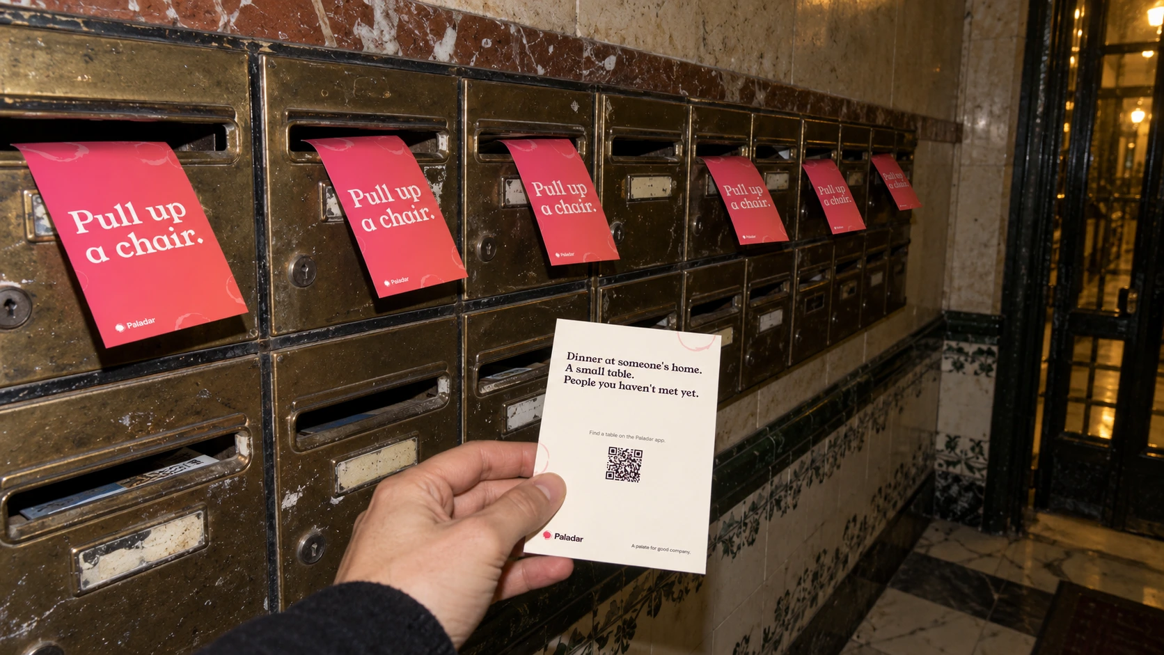 Paladar invitation cards left in the letterboxes of an apartment building. The card reads: Pull up a chair.