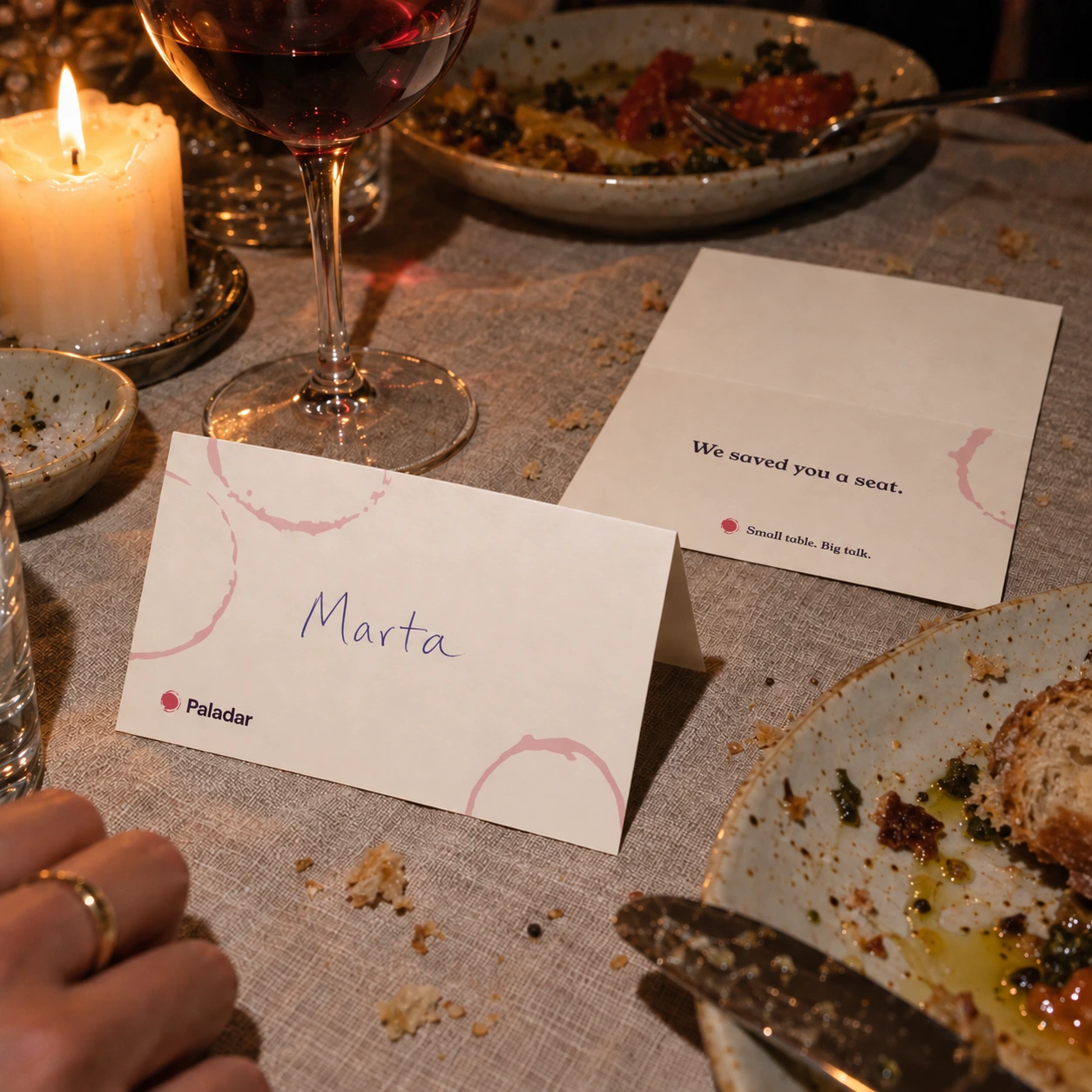 A Paladar place card on a dinner table, with the name Marta written by hand.