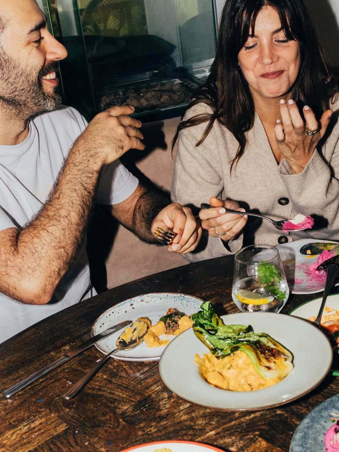 Guests around a table, caught mid-conversation.