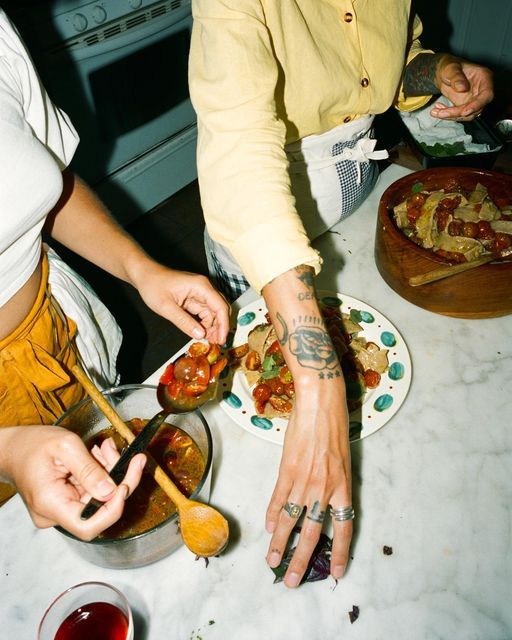 A host plating food in a home kitchen.
