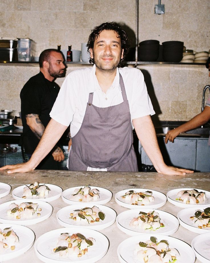 A restaurant kitchen with steel counters and identical plates.